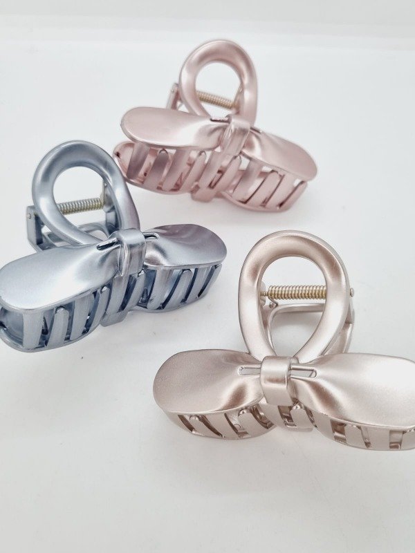 Producto - Broche plastico moño curva metaliz