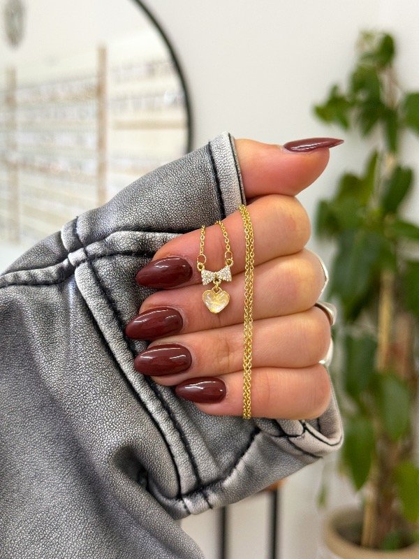 Producto - Cadenita bañada en oro moño micropave corazón tornasolado