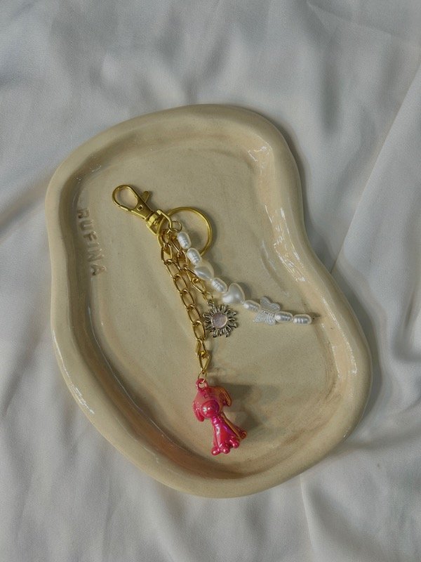 Producto - Bag charm snoopy gold