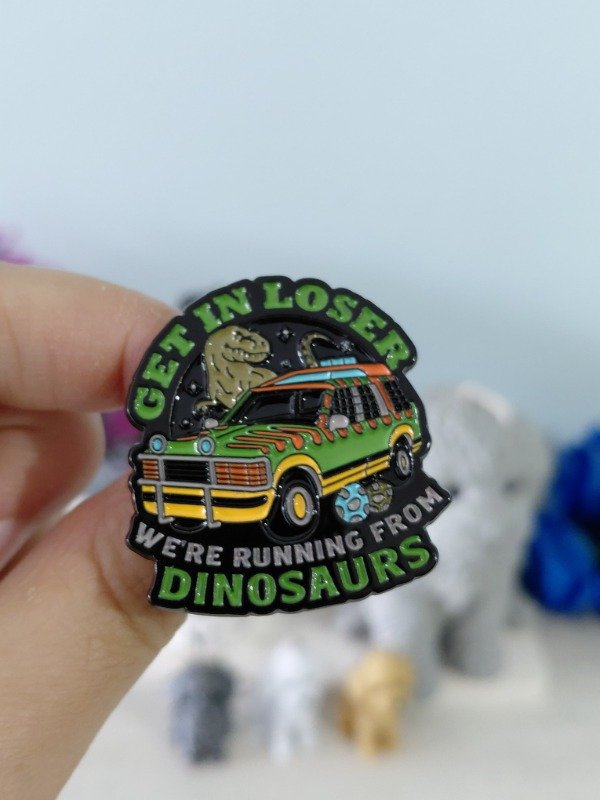 Producto - Pin metalizado - Jurassi Park "Get In Loser, We're Running From Dinosaurs" #2681