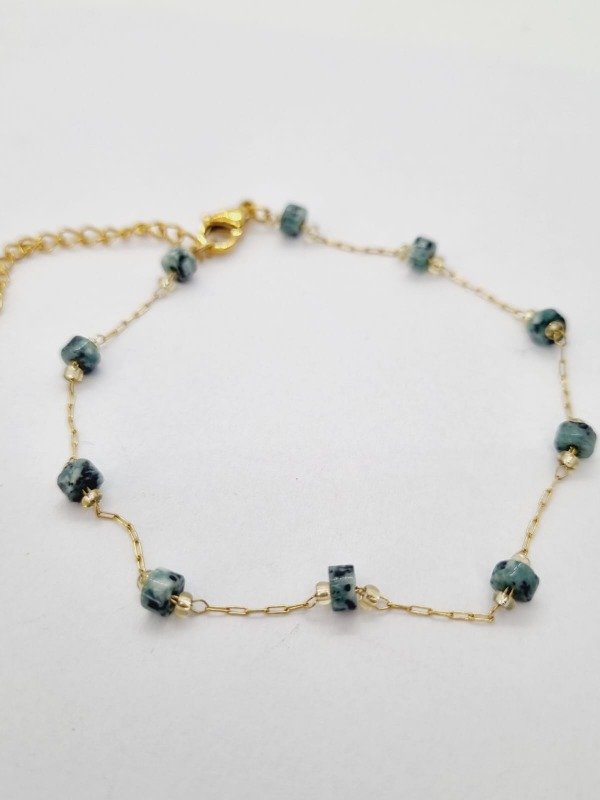 Producto - Pulsera acero dorado fina rueditas sep piedra turquesa