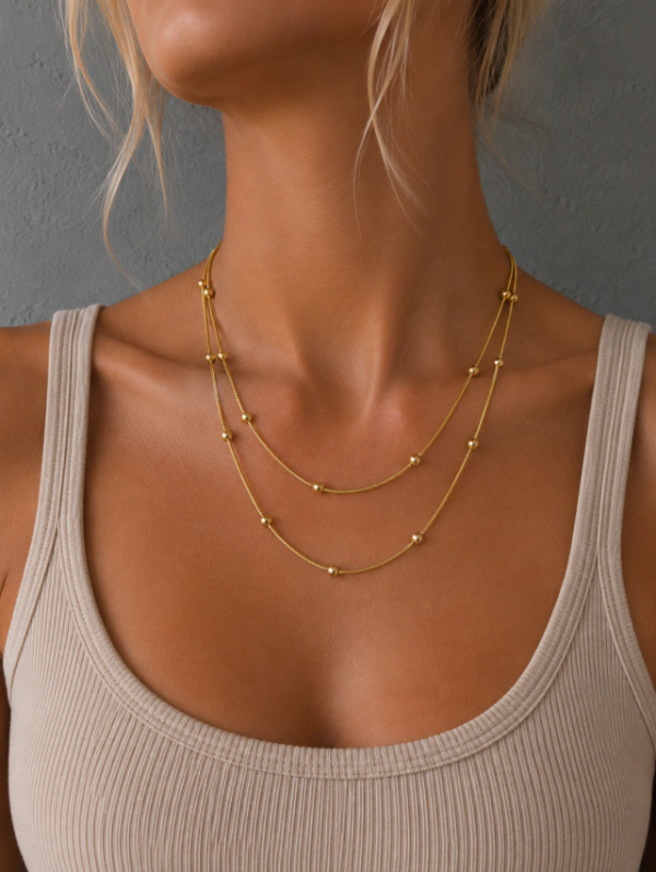 Producto - Collar doble bolitas gold acero quirurgico
