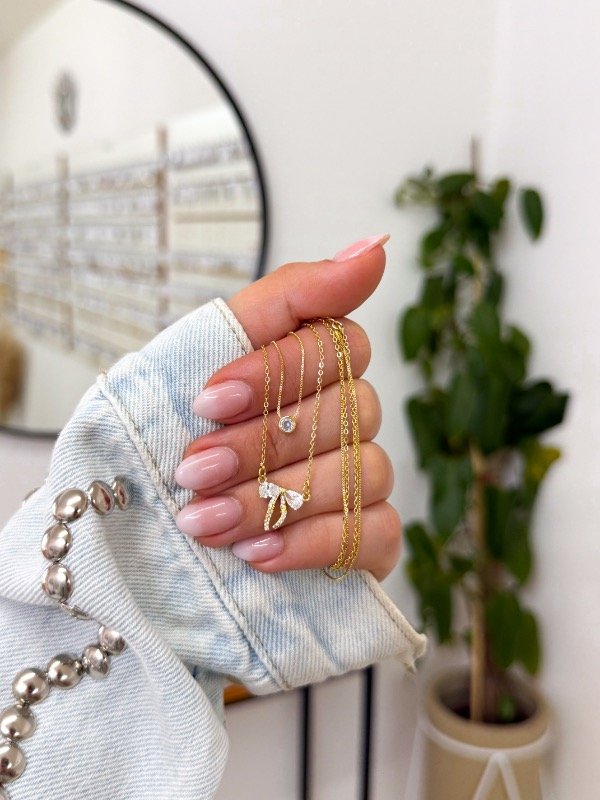 Producto - Cadenita bañada en oro doble moño y cúbic