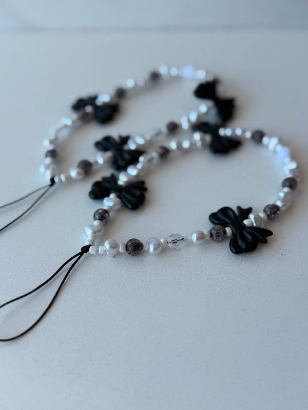 Producto - Strap perlas y moños negro