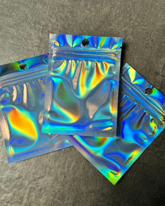 Producto - Bolsas plateadas holográficas con cierre zipper 12 x 17 cm