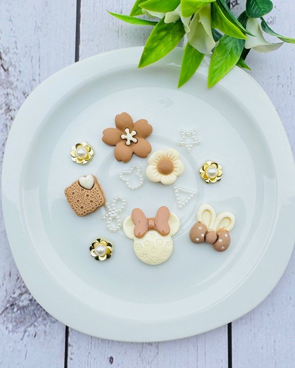 Producto - SET DIJES CHARM DISNEY BEIGE Y CHOCO
