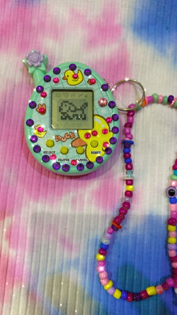 Producto - TAMAGOCHI CON BRILLO Y CORREA