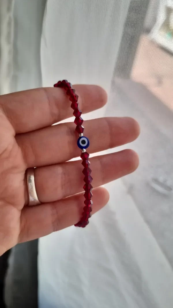 Producto - Pulsera ojito color vino aq