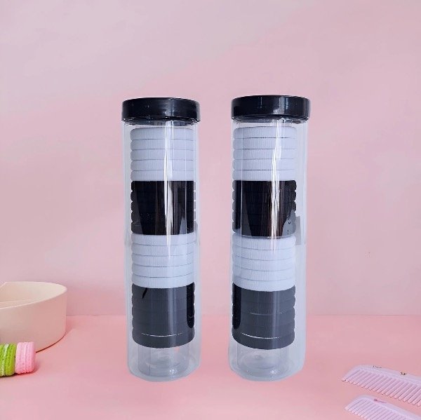Producto - Tubo con 20 colitas para el cabello negras y blancas