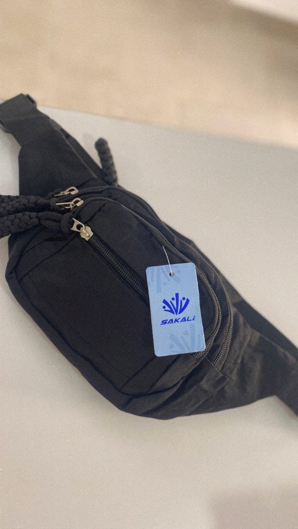 Producto - Riñonera Trenza. Tela impermeable. Negro