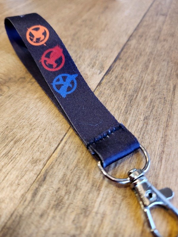 Producto - Llavero cinta "Suerte sinsajo"