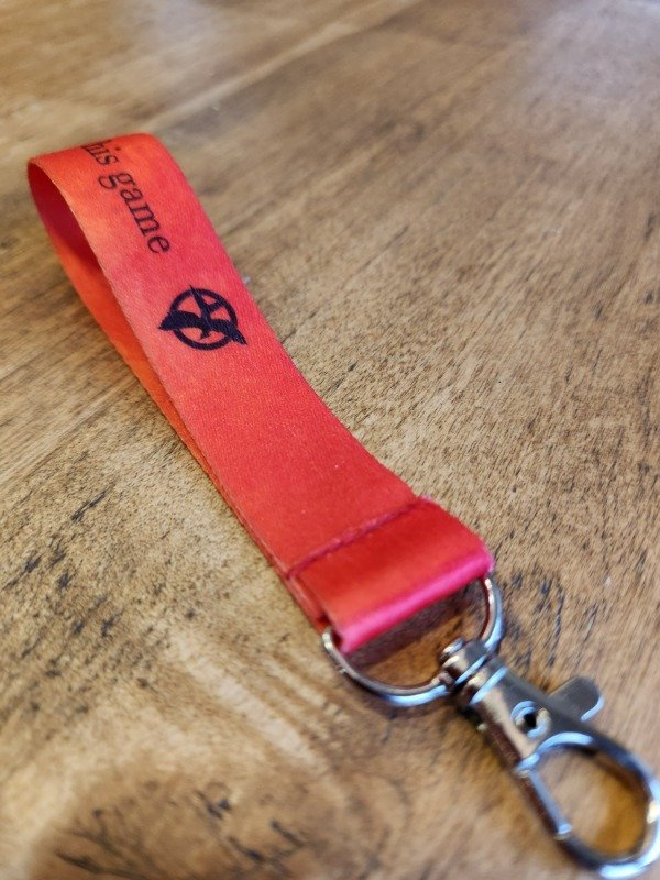 Producto - Llavero cinta "Los juegos del hambre"