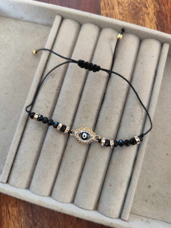 Producto - Pulsera hilo ojito negro.