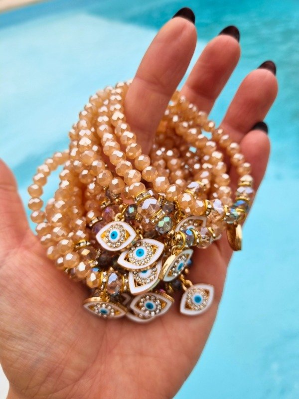 Producto - PULSERA CRISTAL Y STRASS CON OJITO ESMALTADO NUDE/BLANCO