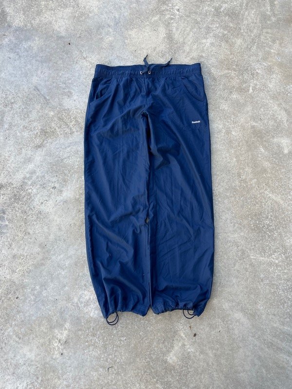 Producto - TRACK BAGGY REEBOOK ROMPEVIENTO
