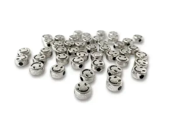 Producto - CUENTAS DE PLASTICO CARITAS 9 MM