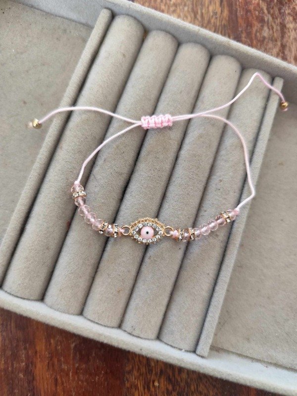 Producto - Pulsera hilo ojito rosa.