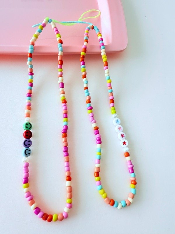 Producto - Correa para celular larga caritas o estrellas