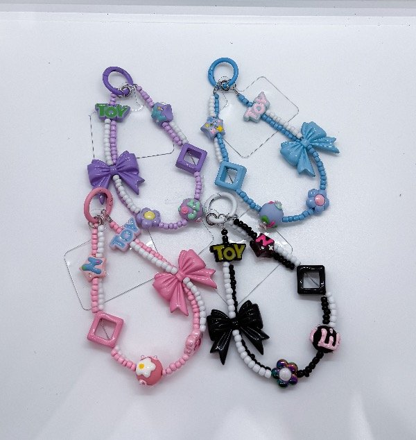 Producto - Llaveros moños pulsera para celular surtido (900086)